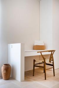 a table and a chair in a room at Trulli Cicerali , trulli design con piscina panoramica in Ostuni