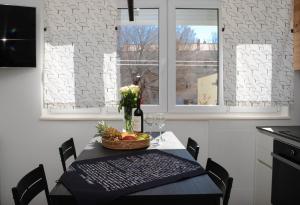 a dining room table with a basket of fruit and a window at New! Urban apartment with free parking in Trogir