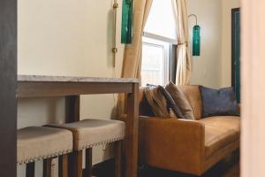 a living room with a couch and a window at Downtown Colorado Springs House in Colorado Springs
