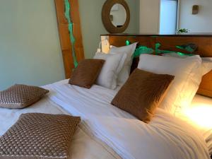 a bedroom with two beds with pillows and a mirror at 2 A 2 in Montélimar
