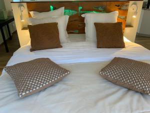 a large white bed with two pillows on it at 2 A 2 in Montélimar