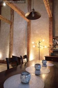 a dining room with a table and a cross on the wall at Gildi Dolce Vita, Tartu Home in Tartu