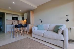 a living room with a couch and a kitchen at Apartment in Fréjus Plage by the seaside with direct access to the beach in Fréjus