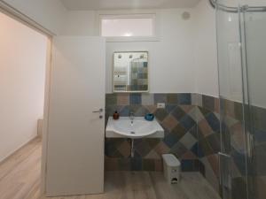 a bathroom with a sink and a mirror at Sorrento Realty Holidays - The smile of the sun in Sorrento