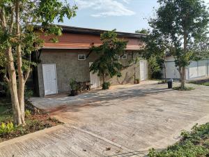 a house with a driveway in front of it at Soysiam in Ban Huai Lat