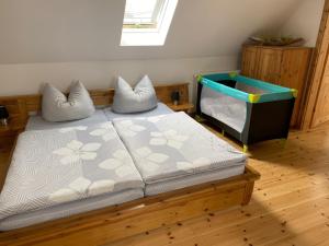 a bedroom with a bed with two pillows on it at Pension Landhaus an der Saale in Bernburg