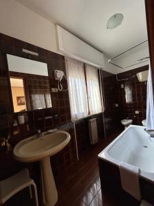 a bathroom with a sink and a bath tub at Elios Apartment in Tropea