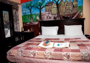 a hotel room with a bed with a tray of food on it at To Be Hotel in Kumasi