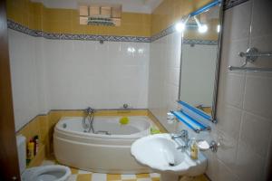 a bathroom with a tub and a sink and a toilet at Villa Maria in Armenoí +19 photos