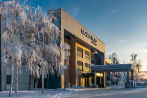 a building with snow covered trees in front of it at Courtyard by Marriott Anchorage Airport in Anchorage