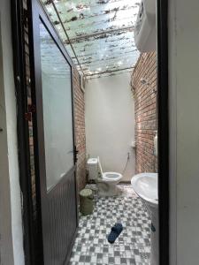 a bathroom with a toilet and a sink at Elephant's House - Đường Lâm Homestay in Hanoi