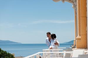 a bride and groom standing in front of a building at BRISTOL Hotel Opatija in Opatija