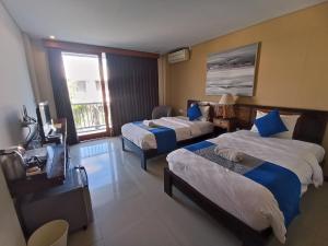 Postel nebo postele na pokoji v ubytování Abian Harmony Hotel
