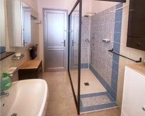 a bathroom with a shower and a toilet and a sink at Maison Marie in Cala Gonone