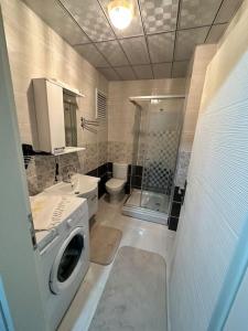 a bathroom with a washing machine and a sink at Akhome - Luxury dublex apartment in Canakkale