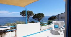a balcony with chairs and a view of the ocean at Maison Marie in Cala Gonone