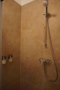 a bathroom with a shower with a shower head at Central City Apartment in Hanover in Hannover