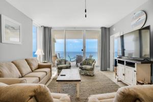 a living room with a couch and a table at Majestic Beach Towers 2-909 in Panama City Beach