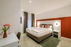 a hotel room with a bed and a desk at Boutique Hotel Piazza Grande in Locarno