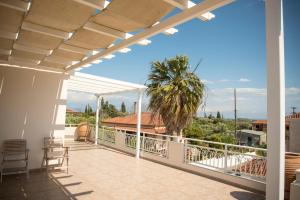 a balcony with a view of a palm tree at Villa Maria in Armenoí