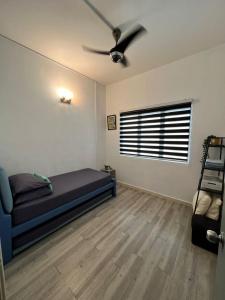 a bedroom with a bed and a ceiling fan at Sunway Alpine Village near Onsen Lost World of Tambun Ipoh Ipoh city in Ipoh