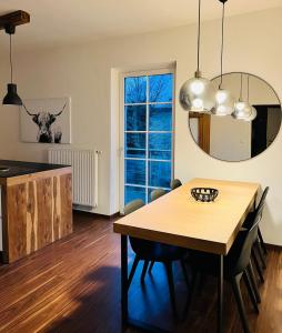 a kitchen and dining room with a table and a mirror at Apartment Leo6 in Salzburg