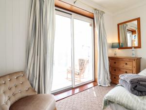 a bedroom with a bed and a large window at Chy Bean in Abergele
