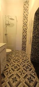La salle de bains est pourvue d'une douche et de carrelage. dans l'établissement Cantina nel Castello, à Montegiovi
