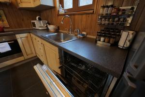 a kitchen with a sink and a dishwasher at Rustic Cottage in Sibiu +77 photos
