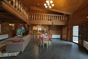 a living room with a couch and a table at Rustic Cottage in Sibiu