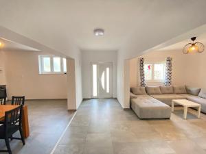 a living room with a couch and a table at Krasa Escape in Novi Vinodolski