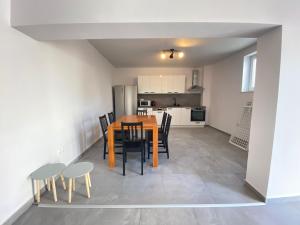 a dining room and kitchen with a table and chairs at Krasa Escape in Novi Vinodolski