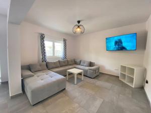 a living room with a couch and a table at Krasa Escape in Novi Vinodolski