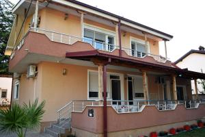 a large house with stairs on the side of it at Vila Marija - Teo in Star Dojran