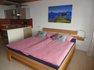 a bedroom with a bed and a kitchen with a sink at Ferienwohnung Moritz in Oy-Mittelberg