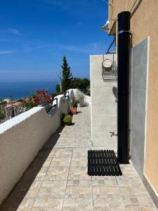 a walkway leading up to a building with a view of the ocean at Vista Stromboli in Paola