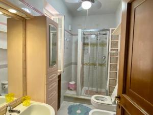 a bathroom with a shower and a sink and a toilet at Sperlonga Paradise Villetta in Sperlonga