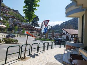 a fence on a street with a street sign at Guest House Noah&Kristel in Berat