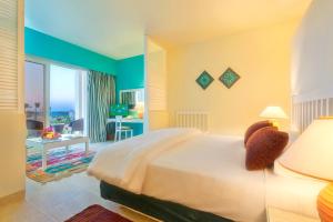 a bedroom with a bed and a room with a desk at Caesar Bay Resort in Marsa Matruh