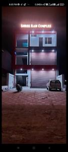 a car parked in front of a garage at night at OYO Gupta Guest House in Morādābād