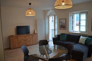 a living room with a couch and a tv at Casa Cristina in Cannobio