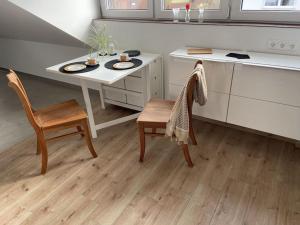 a kitchen with a table and a table and chairs at Zeit zum Wohlfühlen FeWo Hofmark 