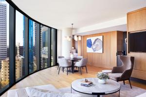 a living room with a view of a city at The Ritz-Carlton, Perth in Perth
