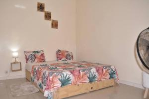 a bedroom with a bed with a colorful comforter at Dakar Top destination 2 in Dakar