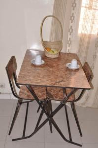 a wooden table and chair with a basket on it at Dakar Top destination 2 in Dakar