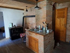 a kitchen with a brick wall and a sink at Vila Hedvika in Nové Hrady +12 photos