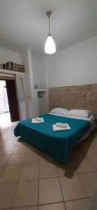 a bedroom with a bed with a blue blanket at B&b Le Monache in Bisceglie