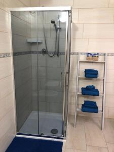 a shower with a glass door in a bathroom at B&B Isola Mia in La Maddalena
