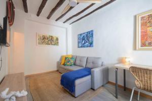 a living room with a couch and a table at The Tile House in Güéjar-Sierra