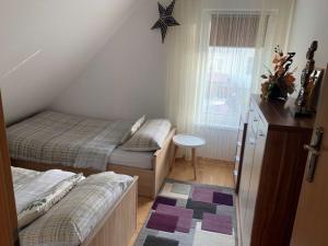 un pequeño dormitorio con 2 camas y una estrella en la pared en Tumidaj Cottage, en Bogacko